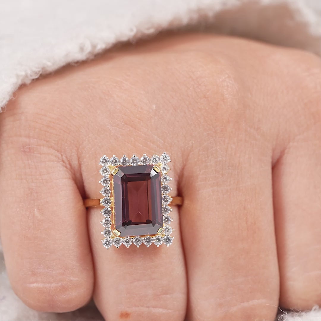 Vintage inspired emerald cut garnet ring with sparkling diamond halo setting