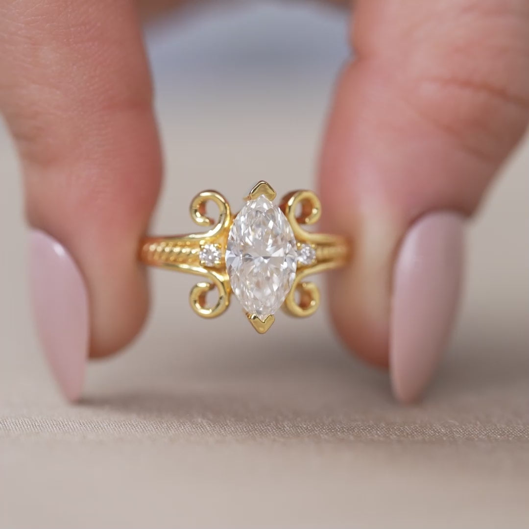 Elegant marquise lab grown diamond ring with decorative gold swirl setting
