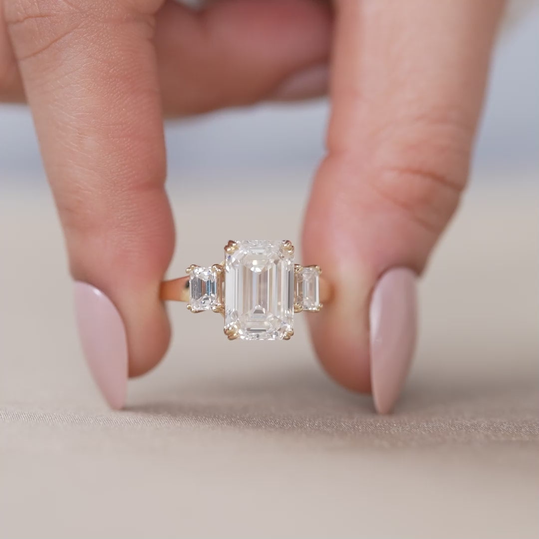 Three stone emerald lab grown diamond ring with tapered side stones