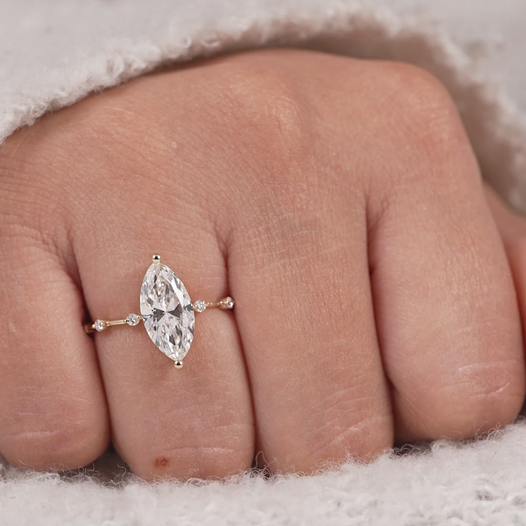 Marquise cut lab grown diamond ring with delicate station diamond band