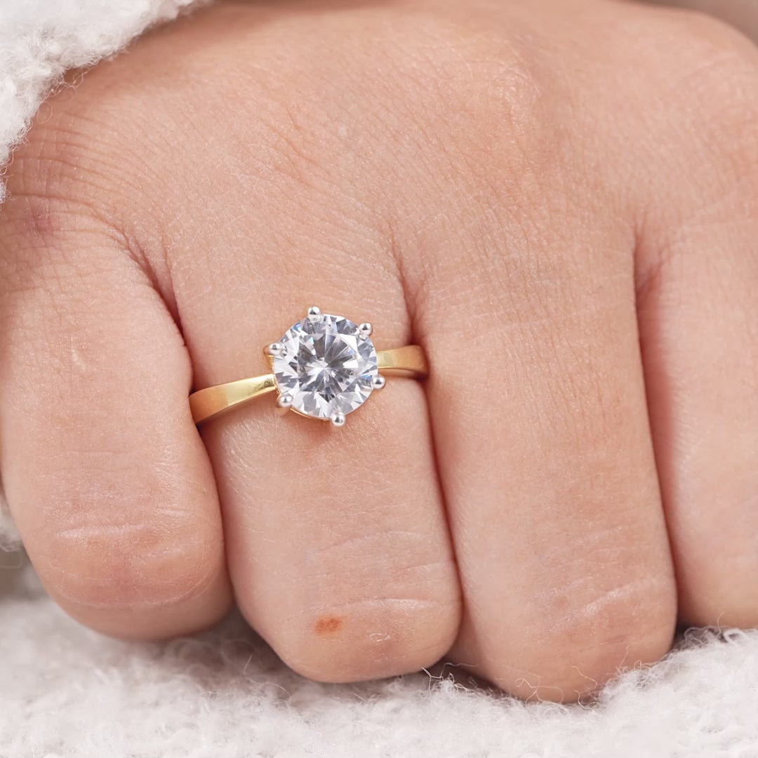 Classic round solitaire engagement ring with white gold prongs and gold band