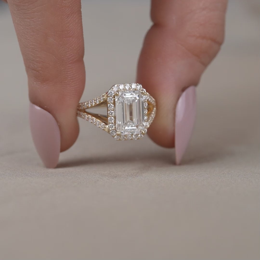 Split shank emerald lab grown diamond ring with pavé halo