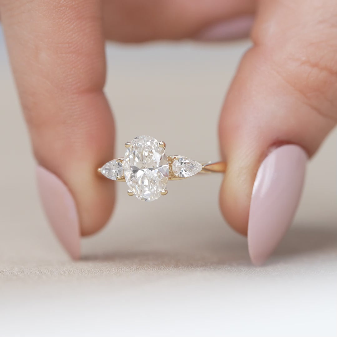 Lab grown diamond oval three stone ring elegant pear side accents