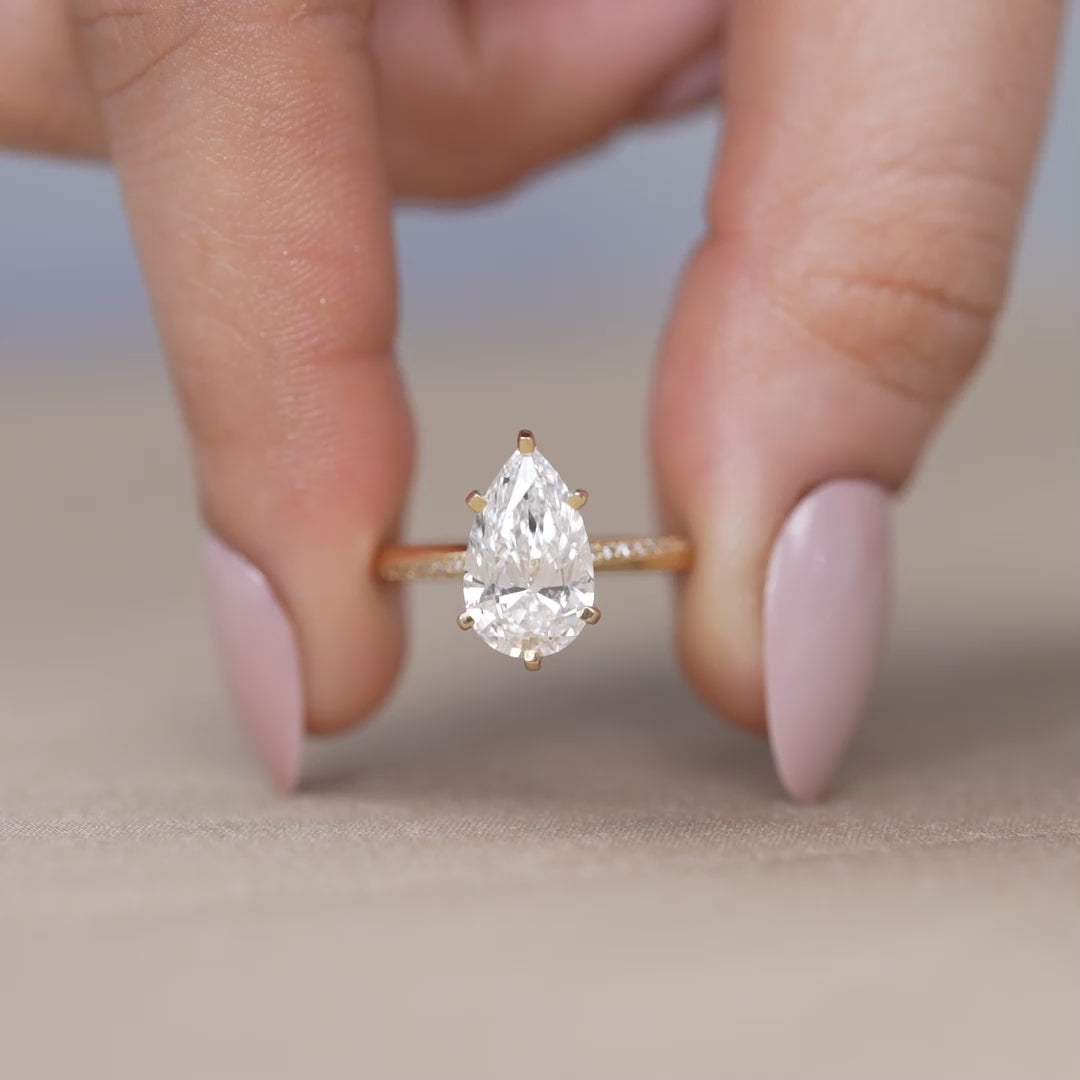 Elegant pear shaped lab grown diamond engagement ring in yellow gold
