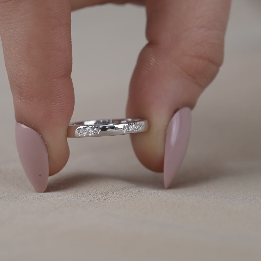 Sleek white gold ring with tiny scattered diamond accents