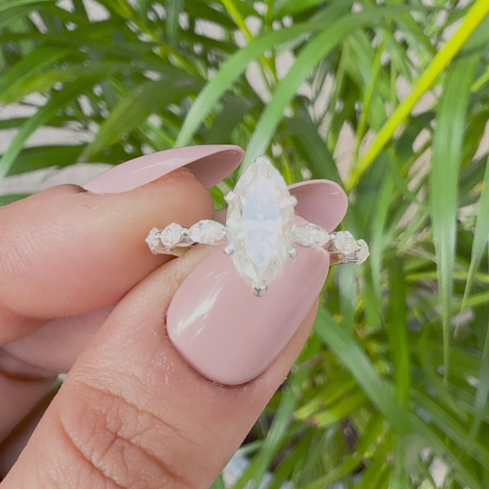 Elegant marquise-cut solitaire engagement ring with marquise-accent band
