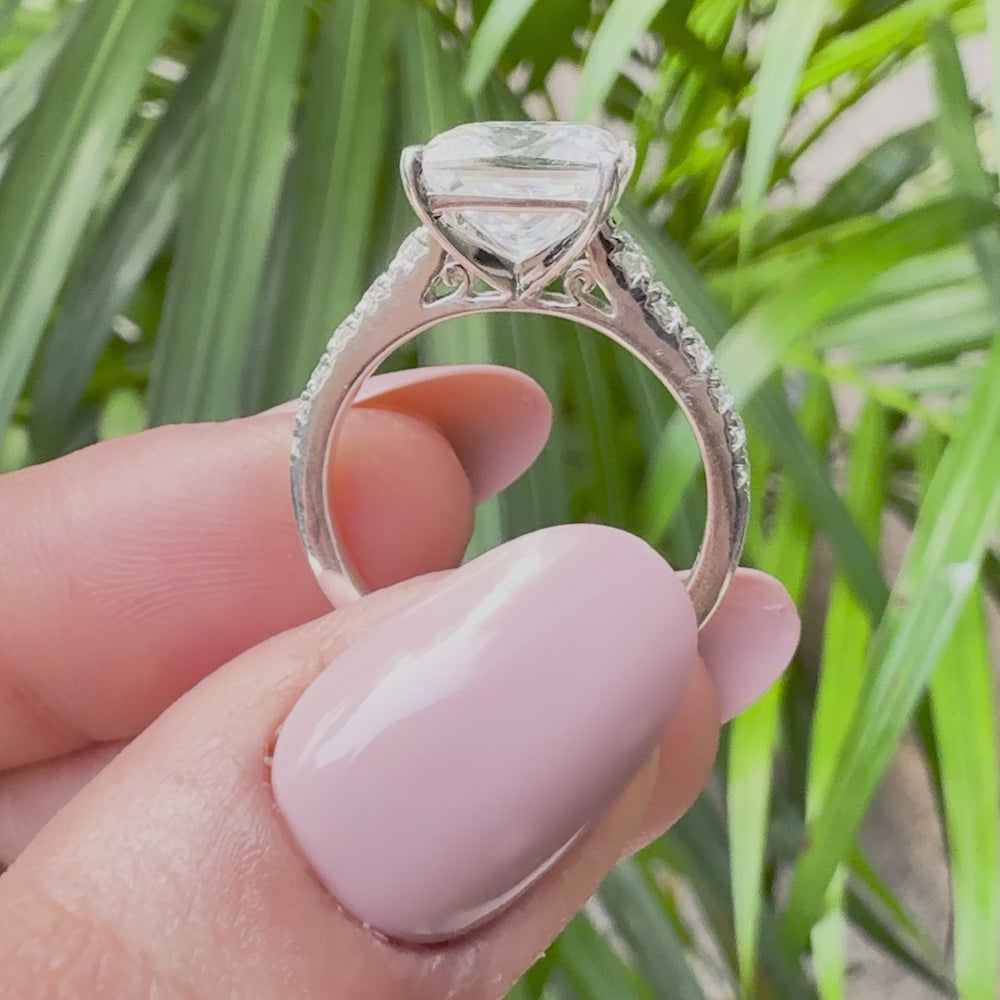 Elegant princess-cut diamond ring set in white gold with accent diamonds