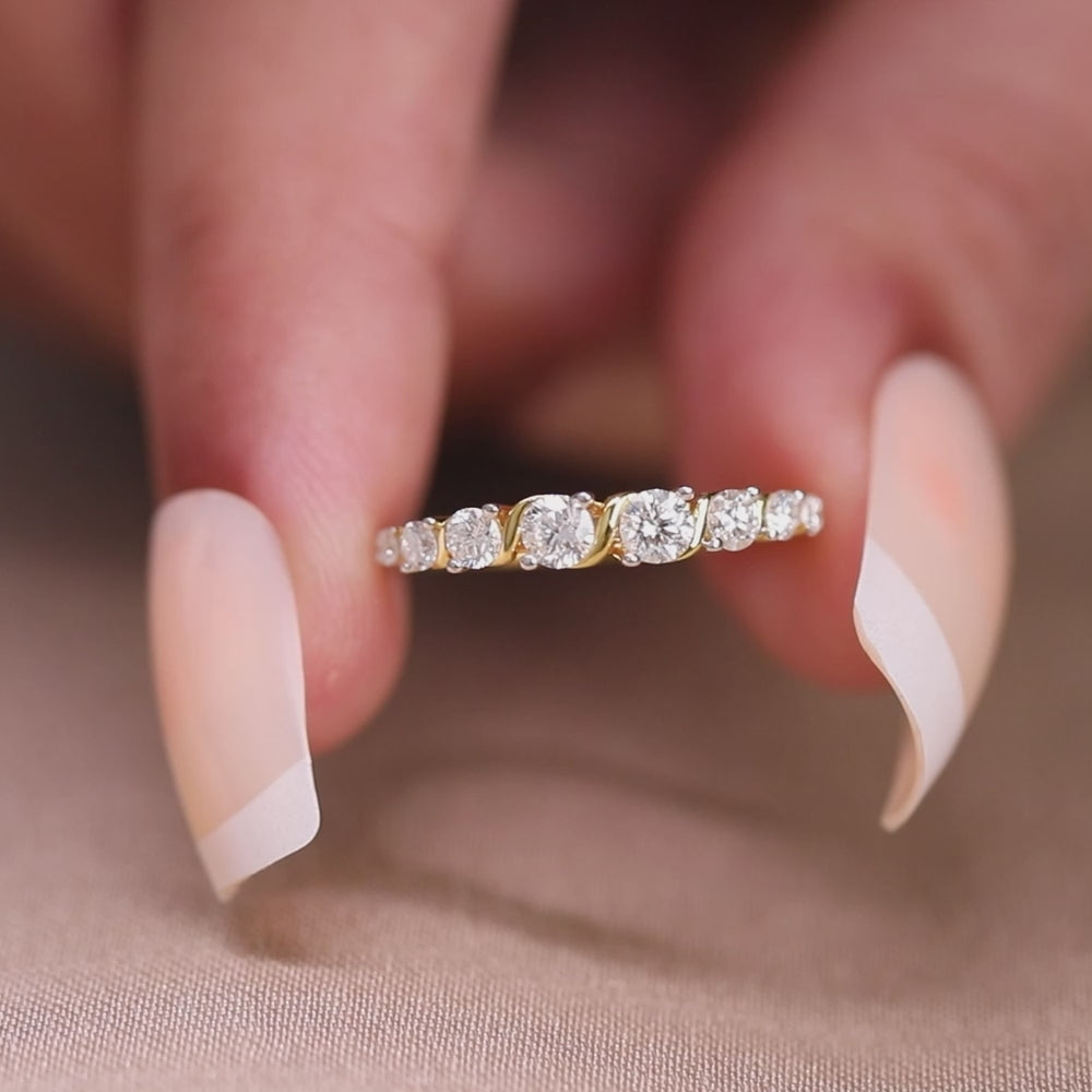 Minimalist gold diamond ring with graduated round stones in a stylish prong setting.