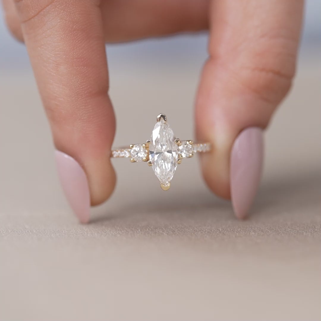 Yellow gold ring with marquise lab grown diamond and side stones