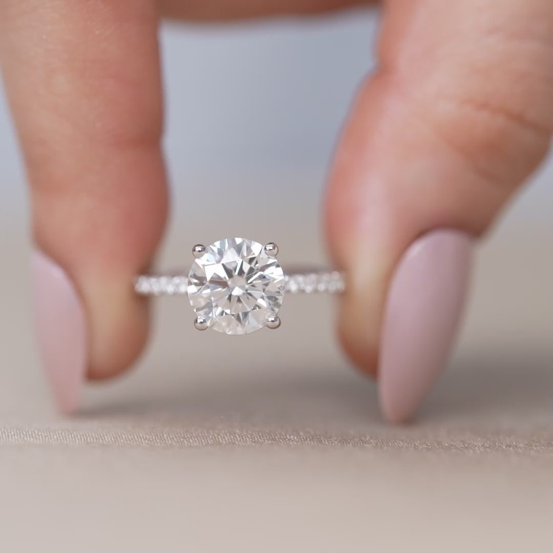 Classic round diamond engagement ring with pavé white gold band