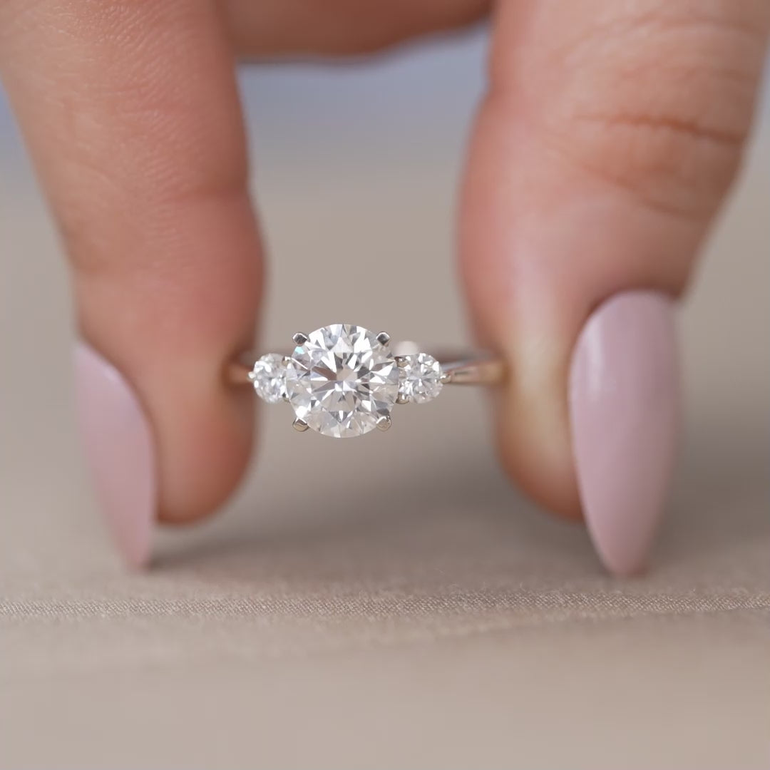 Round lab grown diamond trilogy ring with minimalist white gold band