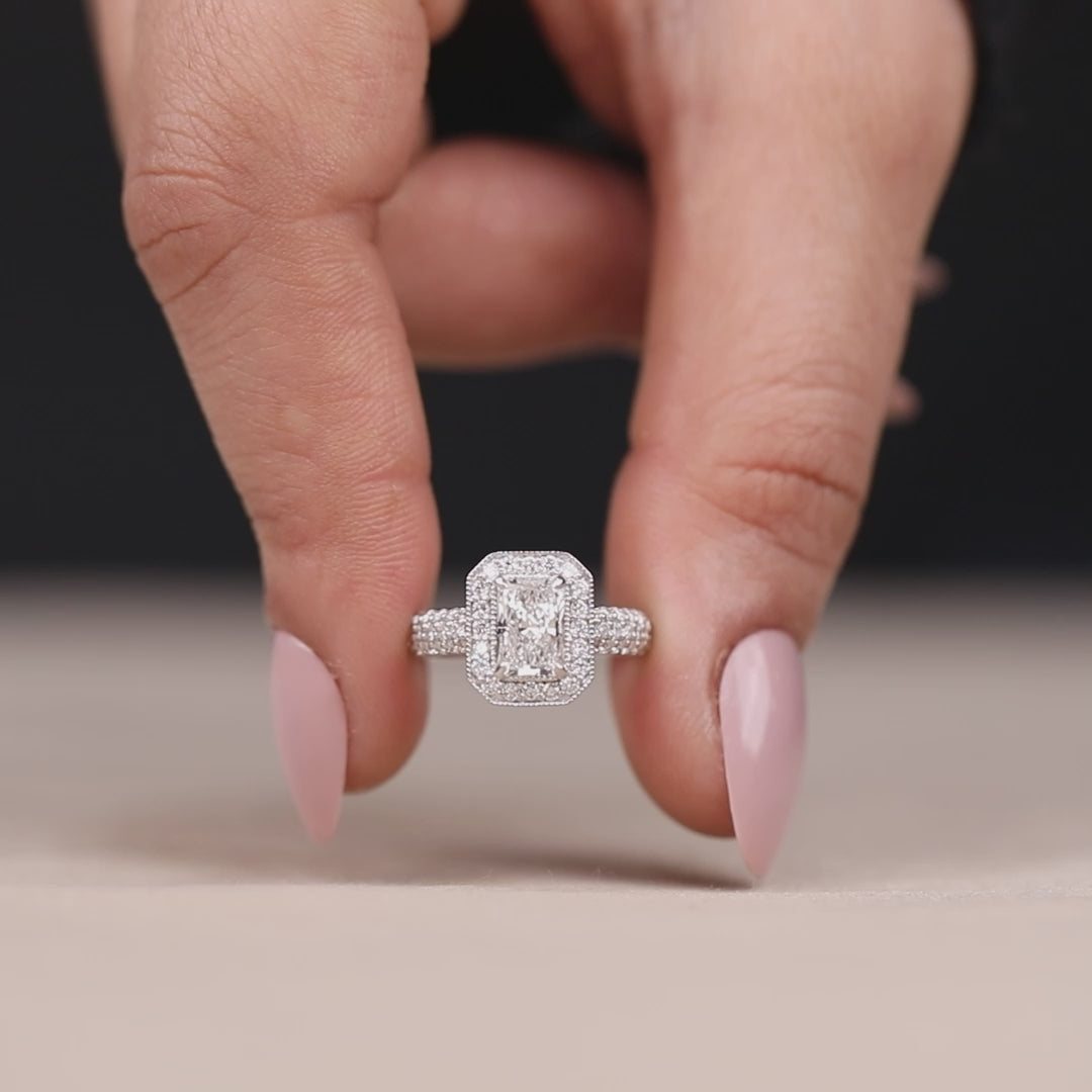 Lab-grown emerald cut diamond ring featuring a classic halo design.